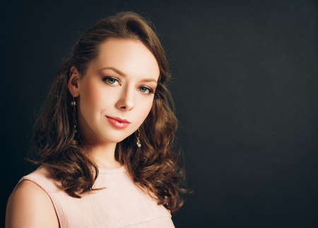 Young beautiful woman studio shot, pretty girl with professional make up 