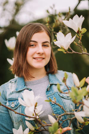 Outdoor portrait of young teenage 16 year old girl, wearing denim jacketの写真素材