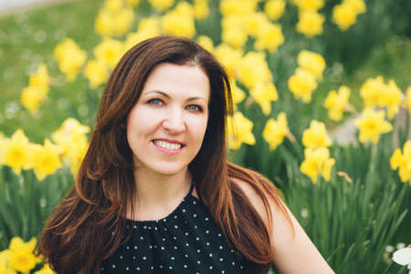 Outdoor portrait of beautiful woman posing in spring park