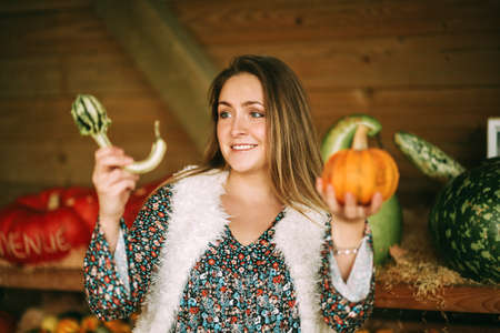 Autumn portrait of young happy woman on farm marketの写真素材