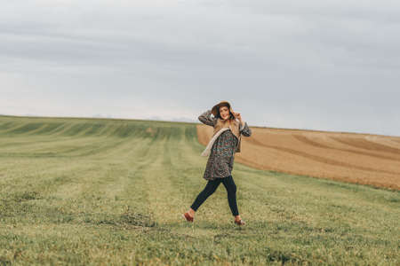 Outdoor lifestyle portrait of young happy woman posing in countryside