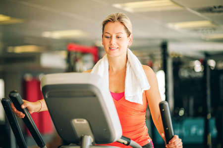 Young strong woman working out with stepper, sport and health lifestyleの写真素材