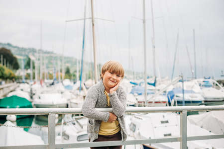 Outdoor portrait of cute little boy spending day by the lakeの写真素材