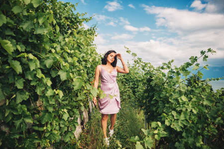Summer portrait of happy young woman hiking in vinyardsの写真素材