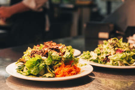 Food orders on the kitchen table in the restaurantの写真素材