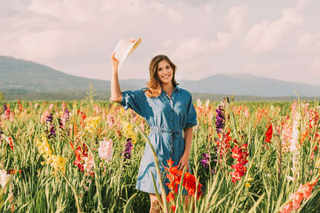 Outdoor portrait of pretty young girl in countryside, wearing denim dressの写真素材