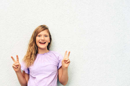 Outdoor portrait of adorable little girl on white background, fashion for kidsの写真素材