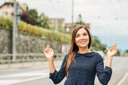 Outdoor portrait of attractive young woman with long brown hairの写真素材