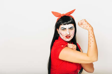 Pop art pin-up stylized studio portrait of young girl with face painting, we can do conceptの写真素材