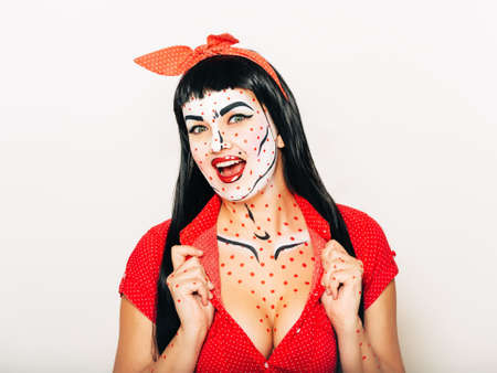 Pop art pin-up stylized studio portrait of young girl with face painting