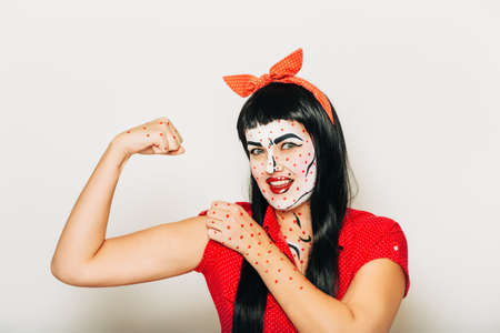 Pop art pin-up stylized studio portrait of young girl with face painting, we can do conceptの写真素材