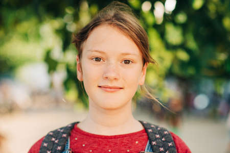 Outdoor close up portrait of cute teenage girl