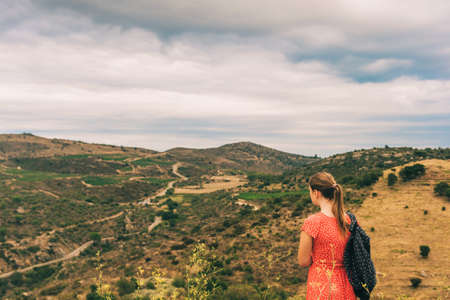 Young girl tourist admiring landscape of Cap de Creus, National Park on the Costa Brava, Spainの写真素材