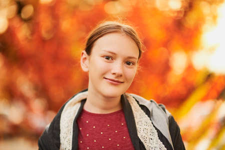 Autumn portrait of pretty young girl taken at sunset