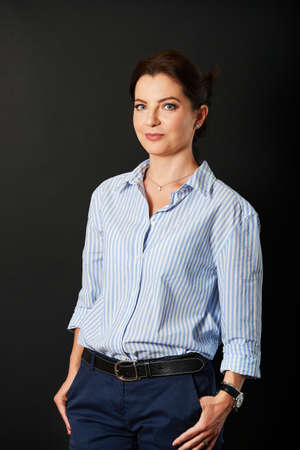 Studio business portrait of beautiful mature woman wearing blue stripe shirtの写真素材