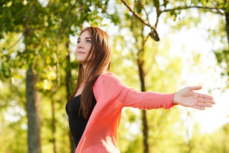 Outdoor portrait of beautiful young woman with brown hair, relaxing in natureの写真素材