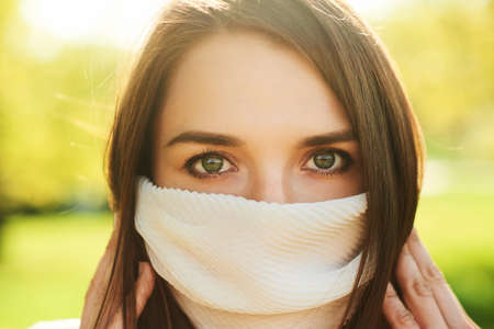 Close up portrait of young woman wearin fashion protection maskの写真素材