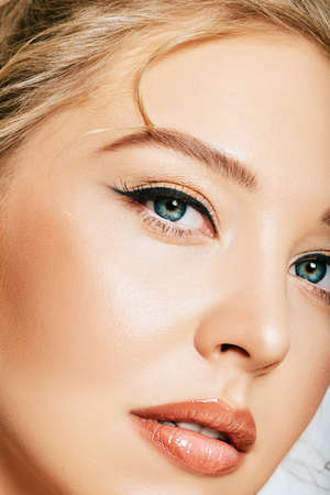 Close up portrait of beautiful young woman on white backgroundの写真素材