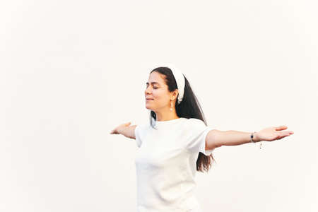 Portrait of happy middle age woman with arms wide openの写真素材