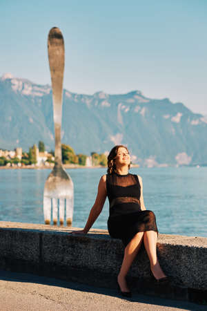Young woman enjoying nice day by lake Geneva in Vevey, famous tourist place in swiss rivieraの写真素材