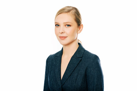 Business portrait of young professional woman, isolated on whire background, wearing grey jacketの写真素材