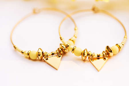 Close up image of handmade modern earrings on white backgroundの写真素材