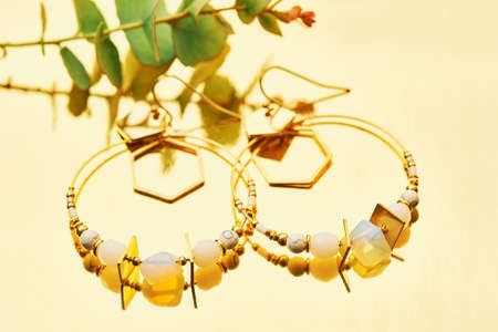 Close up image of handmade modern earrings on mirror backgroundの写真素材