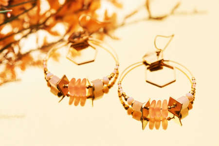 Close up image of handmade modern earrings on mirror backgroundの写真素材