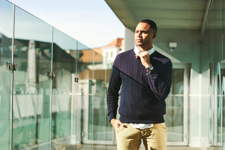 Urban portrait of African American male model posing outside