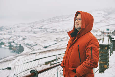Outdoor portrait of middle age man enjoying winter landscape of snowy vinyardsの写真素材