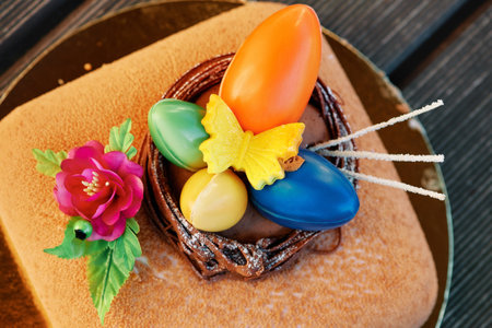 Easter cake decorated chocolate colorful eggs, top view