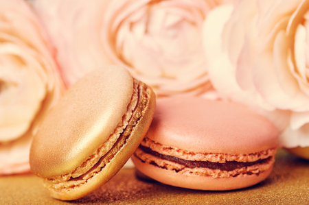 Tender french cookies macaron on golden backgrounsの写真素材