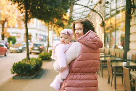 Outdoor portrait of happy young mother holding cute little baby girl, winter in Europe, Montreux, Switzerlandの写真素材