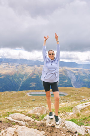 Outdoor portrait of happy young woman hiking in autumn mountainsの写真素材