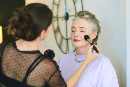 Portrait of middle aged woman at beauty salon getting professional makeup service