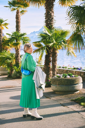 Outdoor portrait of happy mature 50 - 55 year old woman walking by the lakeside, image taken in Montreux, Vaud, Switzerlandの写真素材
