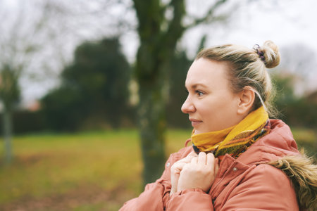 Outdoor portrait of middle age 35 - 40 year old woman enjoying nice fresh day