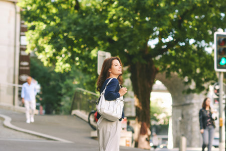 Outdoor portrait of happy mature woman posing on the street, urban lifestyleの写真素材