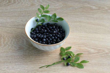 Blueberry in ceramic bowl isolated on white. Fresh blueberry closeup, healthy diet nutrition...