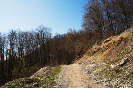 A trail among the mountains. The road up into the mountains. Stony pathの写真素材