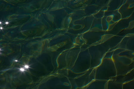 Glare of sunlight on the water. Background, texture of water and light