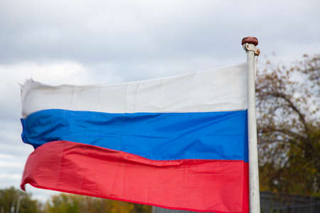 The Russian flag, growing in the wind. Flag of the Russian Federation in the open airの写真素材