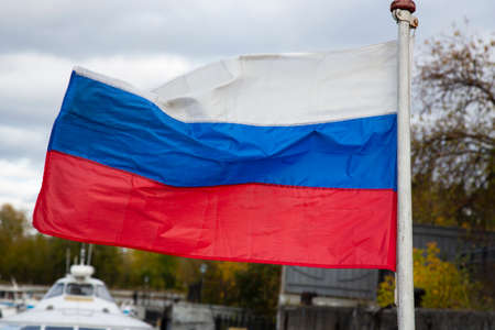 The Russian flag, growing in the wind. Flag of the Russian Federation in the open airの写真素材