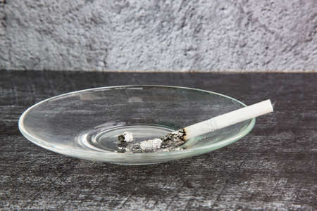 Close up of a cigarette on an ashtray a Bad habit to Quit Smokingの写真素材