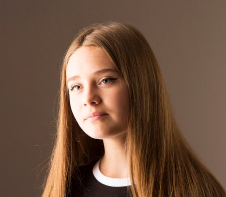 A very beautiful young girl with long blonde hair. The face of an angel. The concept is prayer, hope, faith. Perfect beautyの写真素材
