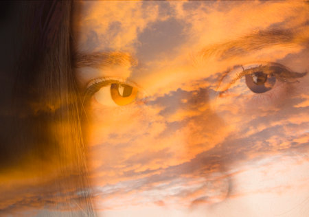 Close-up of a beautiful girl deep hazel eye at orange sunset double exposure, photoshop techniquesの写真素材