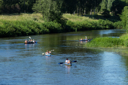 People boating on river, peacefull nature scene on a summer dayの写真素材