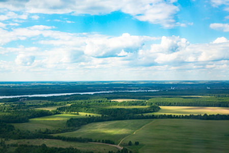 rural landscape from a bird's-eye view. Field, river and sky on a summer dayの写真素材