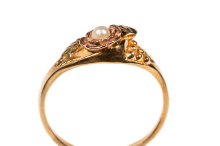 A gold ring with a pearl. Womens jewelry made of yellow gold with beadsの写真素材