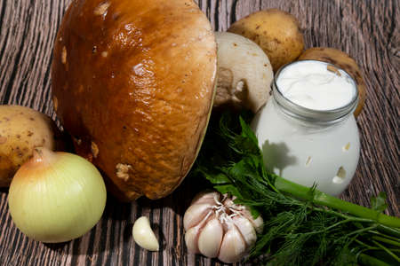 Mushroom Boletus edulis over Wooden Background, close up on wood rustic table. Cooking delicious organic mushroom. Gourmet foodの写真素材